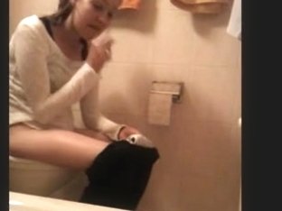 Young Bombshell With Pretty Face Sitting On The Toilet