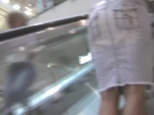 Leggy Babe In Short Skirt Riding On The Escalator