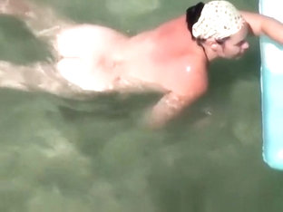 Nudist Woman Swimming In The Beach