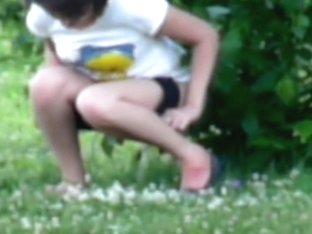 Young Brunette With Sexy Legs Pissing In The Bushes
