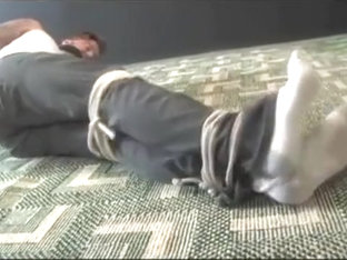 BG Beefy stud in wifebeater and jeans trussesd up and gagged.