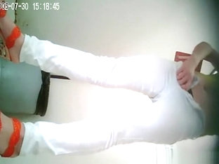 Asian woman in white pants pissing