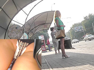 Blonde waits for a bus in the upskirt outdoor scene