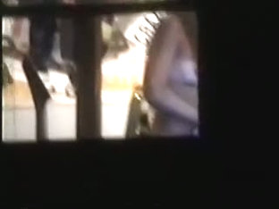 Sexy chick naked on a window voyeur video