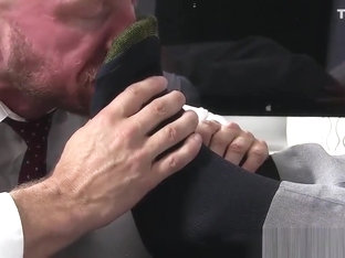 Handsome businessman feet worshiped by his new partner