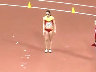 Raven-haired athletic babe competes in long jump