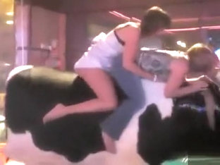 Sweet thing reveals her round butt while riding on a bull