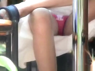 Pink panties filmed under table