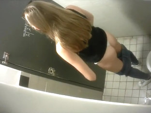 Slim Long-haired Brunette Takes A Quick Whiz In The Restroom
