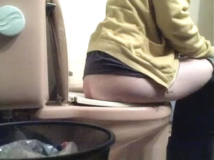 Girl lifts toilet seat and seats to take a pee