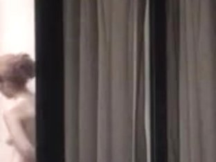 Sexy Blonde Stripping Next To A Window Caught On Voyeur Cam