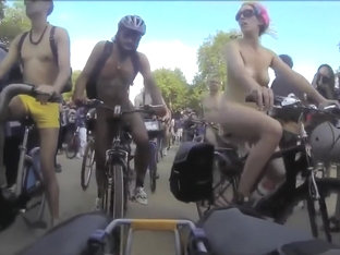 Group of nudists cycle through a town in their birthday suits