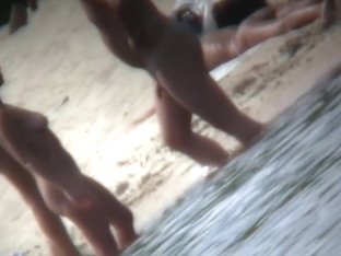 Cheerful Couple Having Some Good Time Naked On The Beach
