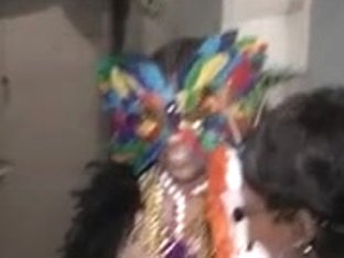 Dark hottie in mask flashes titties to crowd