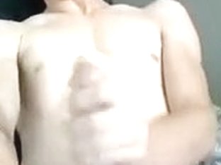 Dishy man is playing within doors and filming himself on webcam