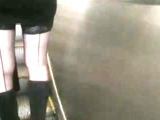 Girl in seamed stockings on escalator