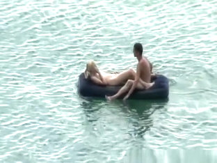 Group Of Nudist In Air Mattress In The Water