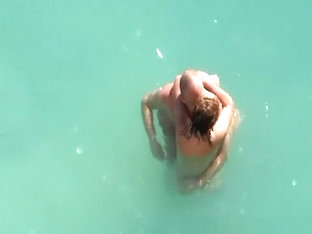 Nude couple fucking in water