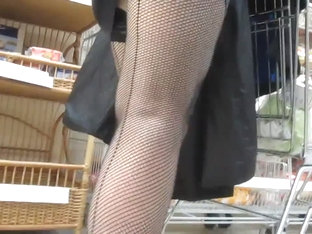 Touching Her Legs In A Seamed Fishnet Stockings In Market
