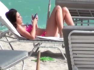 Beautiful and sexy dark-haired minx rests on the beach