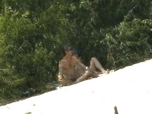 Couple Taking Sunbaths And Walking Nakes On The Beach