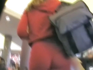 Cute blonde woman is pink dress has a very cool ass