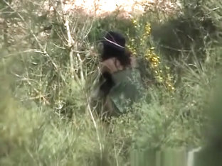 Brunette spied pissing in the bushes