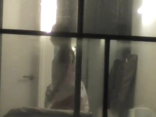 Voyeur neighbor films couple through window