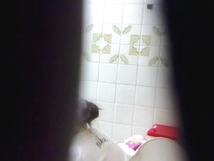 Peeing babe filmed from a far by a hidden camera