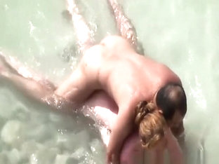 Wife strokes mans penis in beach