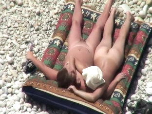 Nudist couple tanning and relaxing