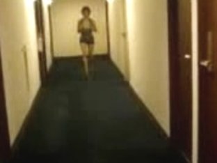 Long-legged chick flashing her tits in a hotel hallway