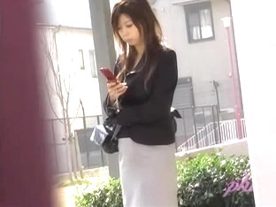 Busy attractive Asian hottie is typing text message during instant sharking