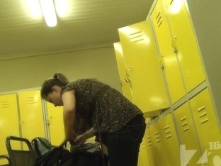 Long-haired Babe Fold Her Clothes In The Locker