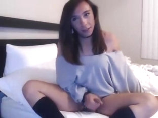 Cute tranny in bed stroking her cock