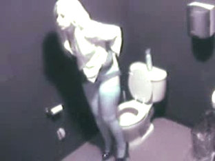 Blonde in high heels and lingerie rubs pussy in toilet voyeur