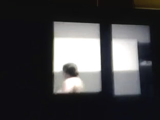 woman spied topless through window