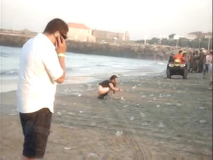 A fresh boozed girl pissing in public on the beach