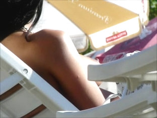 Hidden cam on beach topless brunette