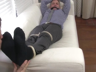 Aged yuppie Brendan Cage is restrained and foot worshipped
