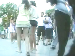 Couple of smokin brunettes in an upskirt public square ass video