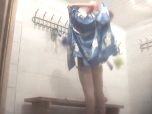 Girl puts on clothes after she has taken a shower