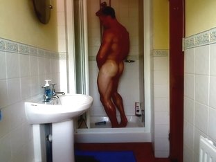 Muscle Hunk Adam Flexing In The Bathroom Showering