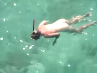 Nudist Woman Swimming In The Water