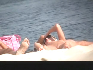 Nude Woman In Nudist Beach Sunbathing