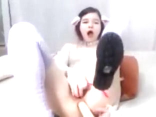 Asian girl dildoes her ass