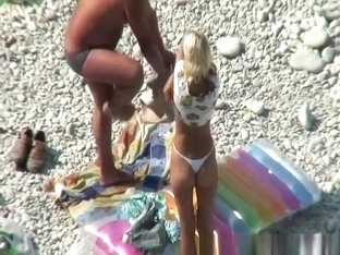 Couple Undressing In Beach