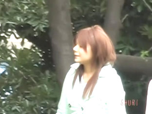 Adorable Jap bimbo gives a hot blowjob in a public park