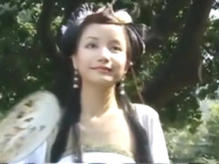 Beautiful Chinese Girl Walks Through A Garden