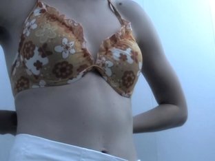 Cute teen bimbo is changing in dressing room showing tits